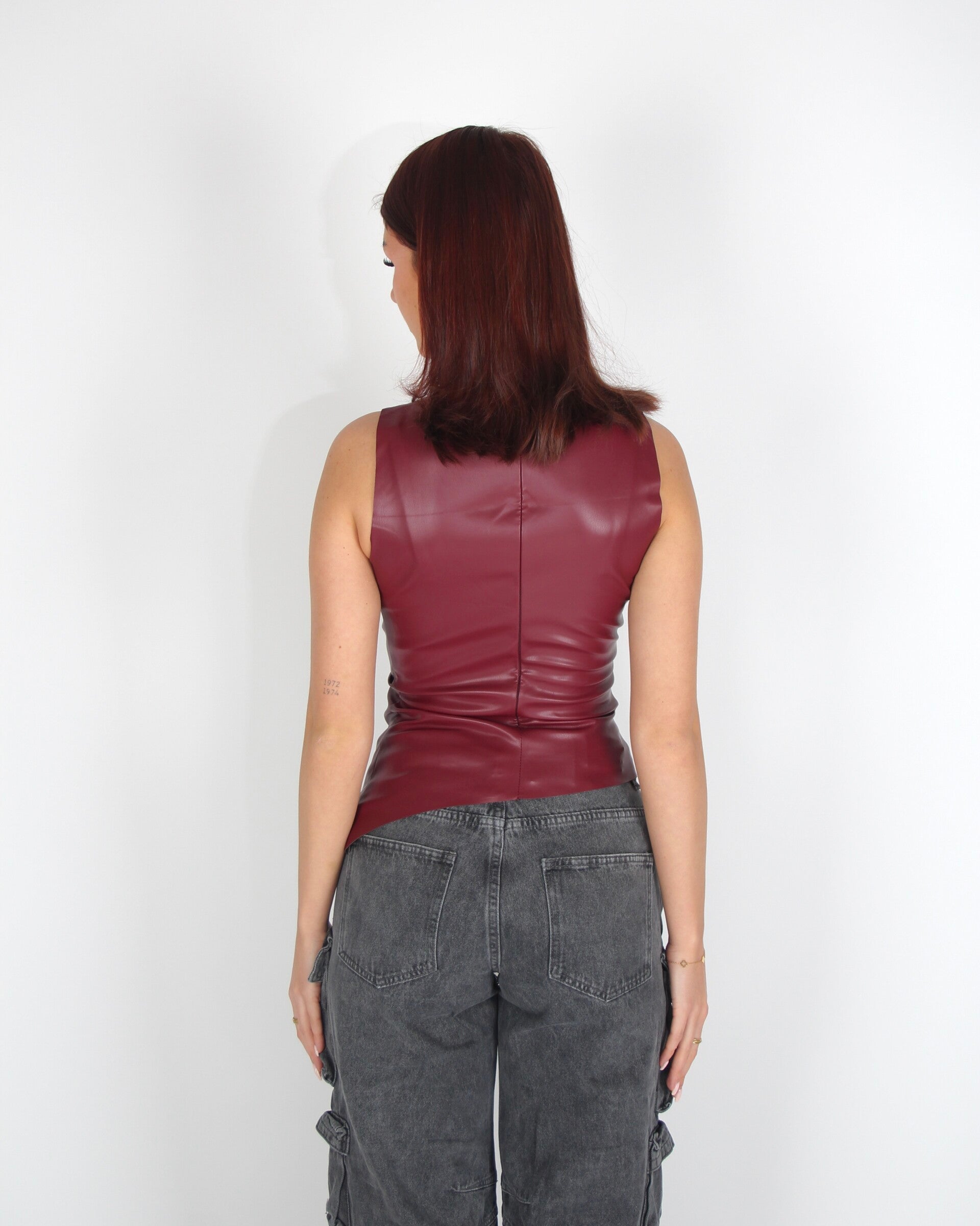 Asymmetrical draped faux leather top